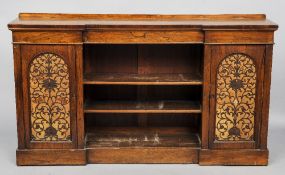 A Victorian rosewood side cabinet
Of inverted breakfront form, with twin fret carved panelled