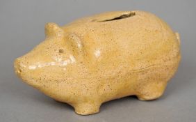 A 19th century glazed stoneware pig form money box
Typically modelled.  12.5 cm wide. CONDITION