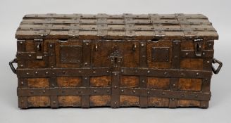 A 16th/17th century iron bound oak church coffer
Of hinged rectangular form with iron strapwork