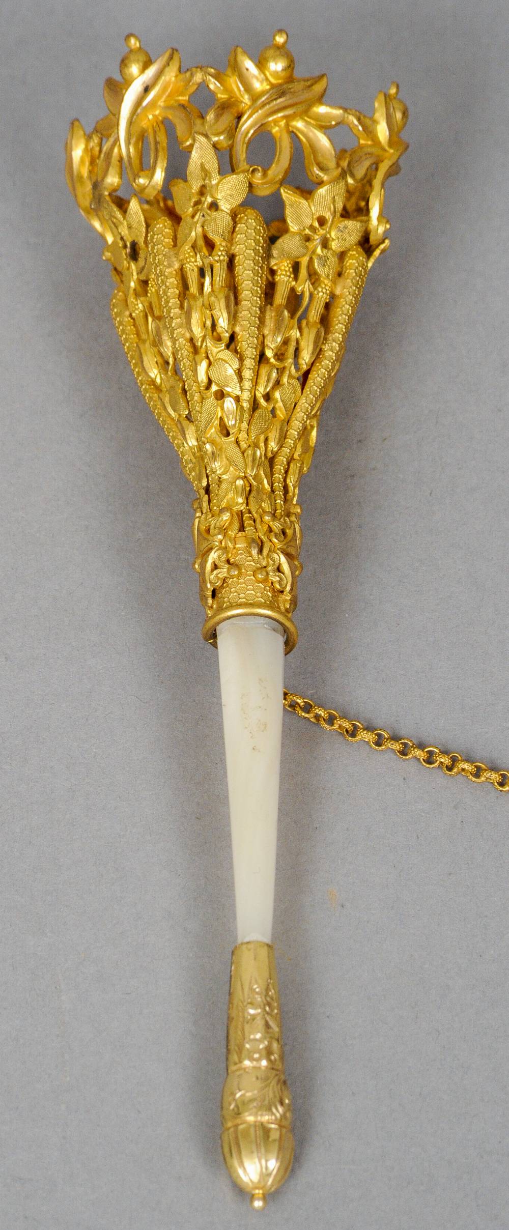 A gilt metal and mother-of-pearl posy holder
The basket pierced and foliate cast.  14.5 cm long.