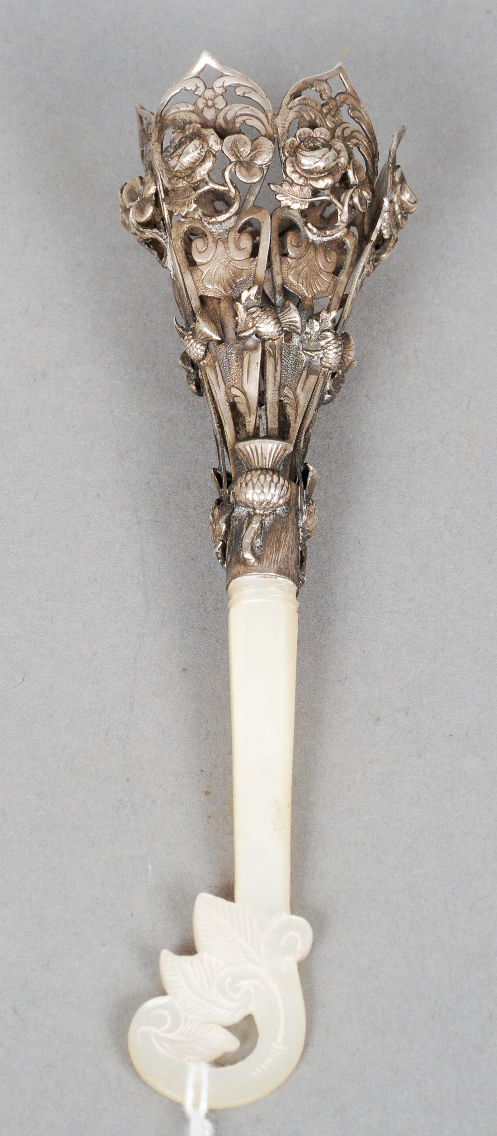 A 19th century white metal and mother-of-pearl posy holder
The basket pierced and florally cast, the