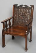 A Chinese carved rosewood open armchair
The pierced back carved with dragons issuing twin arms