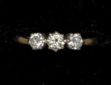 An 18 ct gold three stone diamond ring