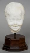 A white marble head study
Mounted on an octagonal wooden display stand.  30 cm high. CONDITION