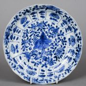 A Chinese Kangxi blue and white plate With floral decoration, the underside with blue painted