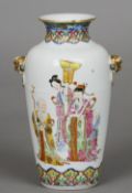 A 19th century Chinese famille rose vase
The twin mask handled ovoid body decorated with courtly