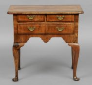 An 18th century and later walnut lowboy
The line inlaid shaped rectangular top above two short and