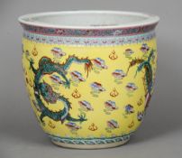 A Chinese yellow ground jardiniere
Decorated with dragons and phoenix chasing a flaming pearl.