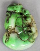 A Chinese carved jade pendant
Formed as a small animal amongst rockwork.  6.5 cm long. CONDITION