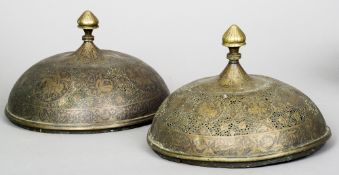 Two 19th century Persian brass food covers
Each of typical pierced dome form with vignettes of