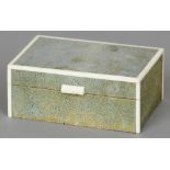 An Art Deco ivory mounted shagreen cigarette box
Of hinged rectangular form with ivory bandings