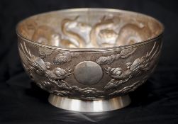 A late 19th/early 20th century Chinese silver bowl 
Decorated in the round with dragons chasing a