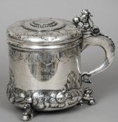 A Swedish silver lidded tankard
The hinged lid cast with a lion and centred with a coin, the main