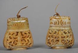 A pair of Chinese carved jade pomanders
Each with pierced baluster body and cover.  5.5 cms