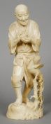 A large 19th century Japanese ivory okimono Formed as an elderly gentleman holding a rabbit, a