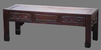 A Chinese carved hardwood coffee table
The moulded rectangular top above the carved frieze, standing