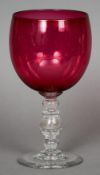 A large Victorian cranberry glass goblet
The stem enclosing a silver sixpence dated 1883.