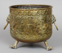 A 19th century brass log bin
The cylindrical body with twin lions mask and loop handles,