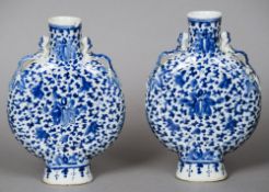 A pair of 19th century Chinese blue and white moonflasks
Each with scrolling floral decoration and