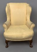 An upholstered wing armchair
With carved cabriole legs with pad feet.  79 cm wide.