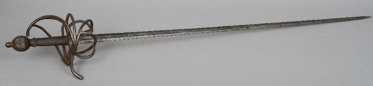 A 17th century basket hilt sword Of typical form, with a gadrooned pommel. 110 cm long. CONDITION