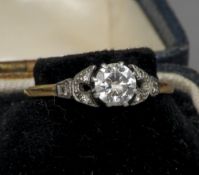 An early 20th century unmarked gold and platinum diamond solitaire ring
The claw set stone flanked