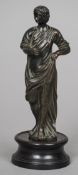 An 18th century bronze figure
Modelled standing in flowing robes, standing on a turned wooden base.