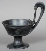 A Roman basalt handled pedestal bowl
With a tall ram's mask loop handle.  28.85 cm high.