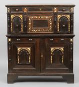 An 18th century inlaid oak two part chest
The moulded rectangular top above two mother-of-pearl