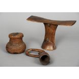 An African carved hardwood headrest 
Together with a Rotse woven gourd shaped vessel and cover;