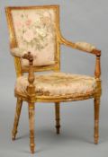 A 19th century upholstered giltwood open armchair
The padded back issuing twin padded open arms with