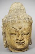 A Chinese terracotta head of Buddha
Typically worked.  31 cm high. CONDITION REPORTS: Old repairs/