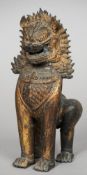 An archaistic style Chinese bronze model of a temple lion
Typically modelled on all fours with