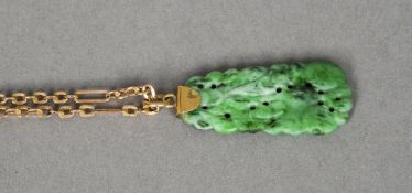 A gold mounted jade pendant 
The pierced rectangular pendant suspended on a gold chain.