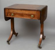 A 19th century inlaid mahogany sofa games table
The hinged twin flap top centred with a removable