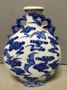 A 19th century Chinese blue and white moonflask 
The ovoid body decorated with bats amongst