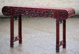 A Chinese carved hardwood altar table
Of typical moulded rectangular form,