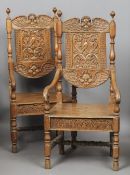 A pair of 19th century carved oak open armchairs
The backs with winged cherubs masks and a bird