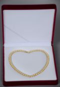 A Chinese cultured gold pearl necklace
With yellow metal clasp, in fitted case.   CONDITION REPORTS: