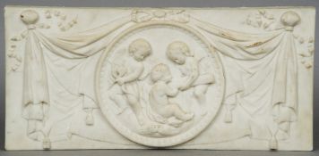 A Victorian marble tablet
Centred with a cherub filled roundel flanked by bow tied swags.