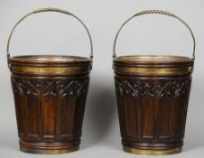 A pair of brass mounted mahogany buckets
Each with a brass loop handle and a brass liner.  Each 46