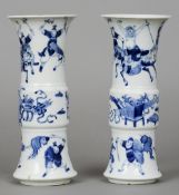 A pair of 19th century Chinese blue and white gu vases
Decorated in the round with warring figures.