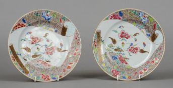 A pair of 18th century Chinese famille rose plates Each decorated with a scroll of floral decoration