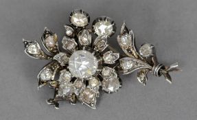 A diamond brooch
Formed as a floral spray set with a main rose-cut diamond to the centre