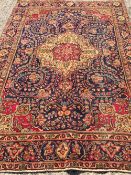 A Tabriz wool carpet
The midnight blue field enclosing a central medallion with pendant palmettes