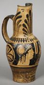 A Roman pottery jug
With anthemion and shell decorations, the front with twin figural profiles.  28.