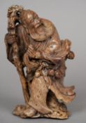 A Japanese carved hardstone figure of a sage
Intricately carved holding a staff and exotic fruit.