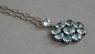 A blue topaz set white metal pendant
Suspended on a silver chain marked 925.  The pendant 3.