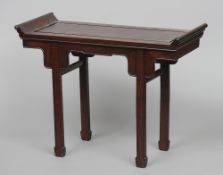 A small Chinese altar table
The moulded rectangular top above a shaped frieze, standing on square