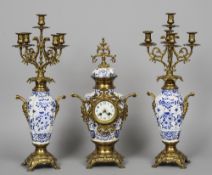 A gilt brass mounted blue and white porcelain clock garniture
Each piece of vase form.  The clock 55